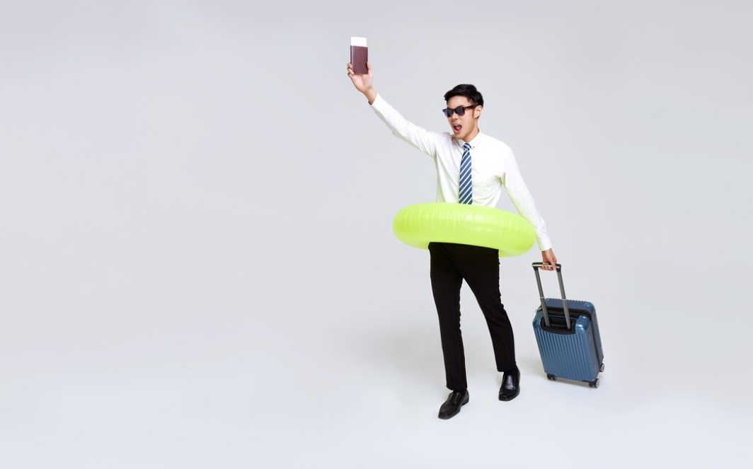 A man with luggage and a floatie taking a selfie