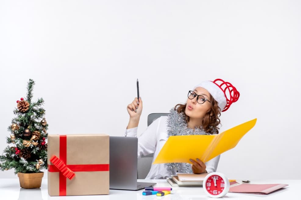 A person in festive attire working at an office desk