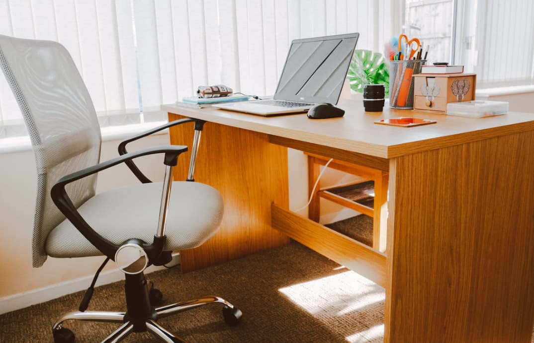 Home office setup with a laptop and chair