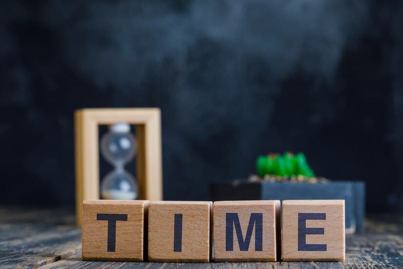 Time Word on Wooden Cubes, Hourglass and Plants