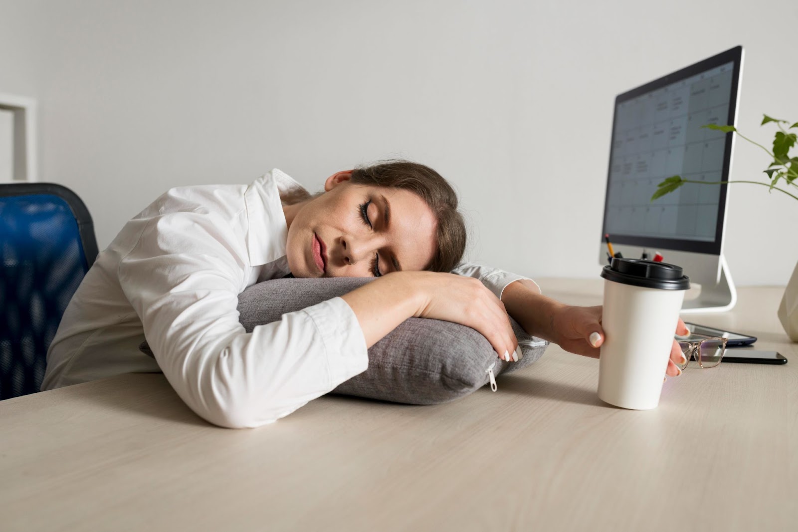Young woman sleeping at work